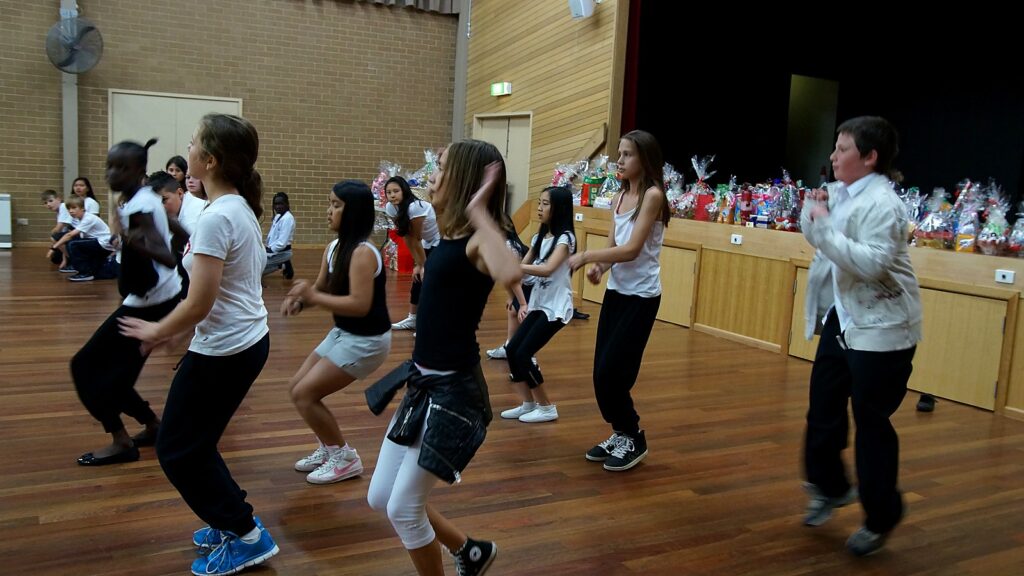 Students learning choreography during a school dance program